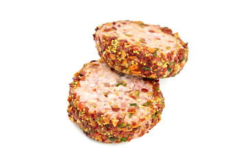 Raw meat patties with spices, two pork cutlets isolated on white