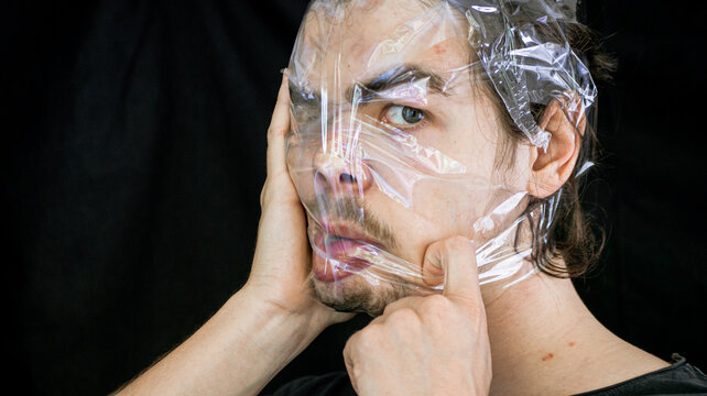 the movements he played with the mad man's face. eye with different looks and crazy head, in front of black background.