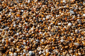 Small pebbles by the sea texture background