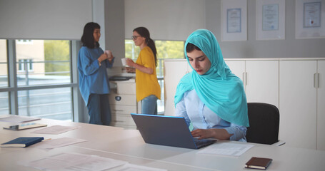 Colleagues bullying female muslim employee at office