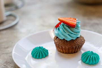 Muffin with blue strawberry cream