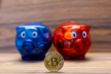 Rotes und Blaues Sparschwein mit einer Bitcoin-Münze