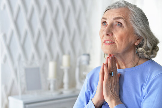 Senior Woman Praying At Home