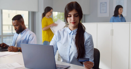 Business woman buying online with credit card.