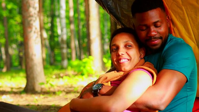 african people on camping trip welcoming a new day in summer park