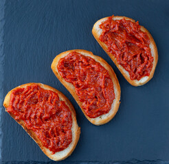 Homemade bruschetta with red pesto sauce