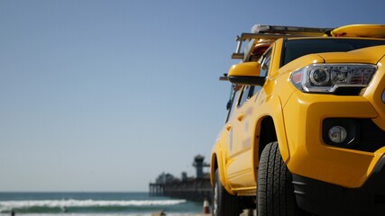 Yellow lifeguard car, Oceanside beach, California USA. Coastline rescue life guard pick up truck,...