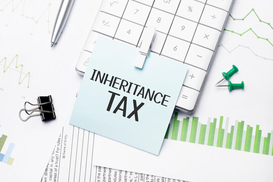 text inheritance tax. Written words on paper notebook . workplace. Business concept.