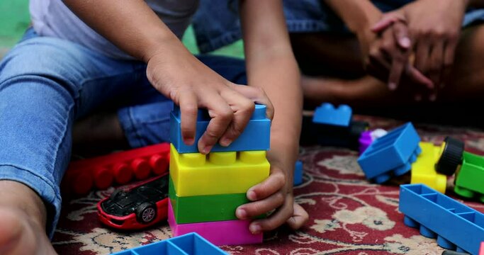 Little girl playing with building blocks. Hispanic mixed race ethnicity