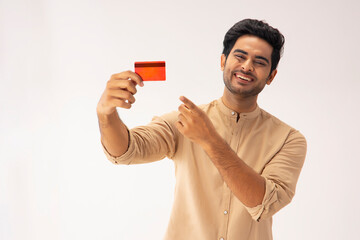 A YOUNG MAN LAUGHING AND POINTING AT DEBIT CARD	