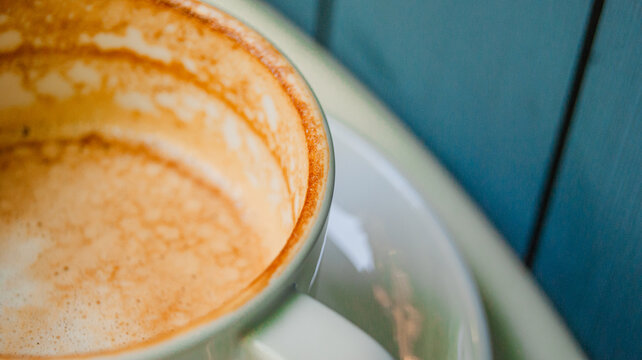 Side shot view of coffee cup. Great colors combined with a great coffee design and shape. Detailed background.