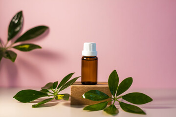 Bottle without label with oil on the stand. Transparent glass container with a dispenser on a beige-pink background. Product banner. Space for text, design.