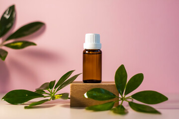 Bottle without label with oil on the stand. Transparent glass container with a dispenser on a beige-pink background. Product banner. Space for text, design.
