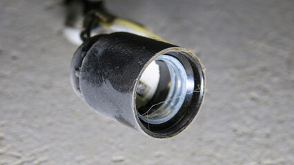 Old socket for incandescent light bulb on the wall