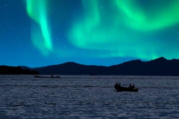 The background of seascape in the night sky of aurora borealis