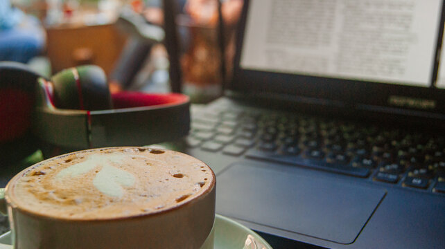 Working hours with a great coffee in the middle of the day. A background with a cafe