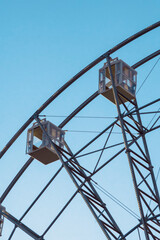 Ferris wheel cabins against the background of the evening blue sky