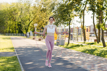 Young sporty woman doing sports outdoors, fitness exercises