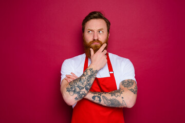 doubter isolated chef with beard and red apron
