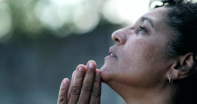 Mature woman praying to God. Hispanic person seeking divine help