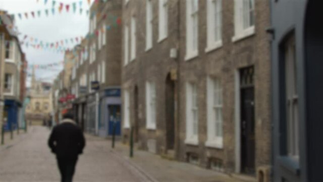 Defocused Tracking Shot Down a Quiet English Shopping Street 