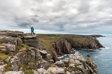 Man taking a selfie on a rock cliff enjoying the view