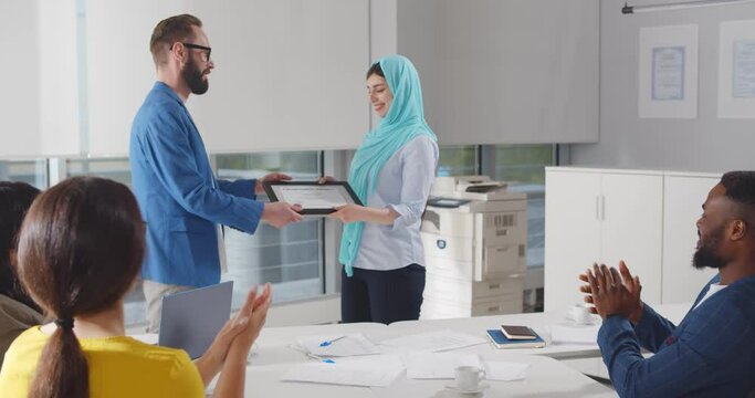 Team leader handshake employee and giving certificate congratulate with professional achievement