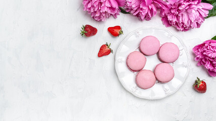 Obraz na płótnie Canvas Pink Macarons, Macaron French delicate dessert on a white background. Long banner format. top view