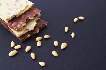four bars of white and milk chocolate with almonds