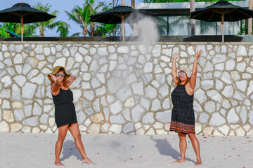 Happy times of twins young asian women enjoy with lovely sister's family at beautiful sand beach on...