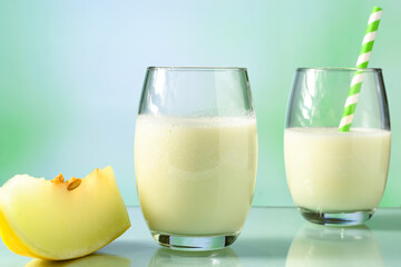  glasses with melon juice with milk and Sicilian lemon on reflective surface