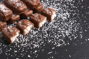 chocolate bars with coconut filling sprinkled with coconut flakes