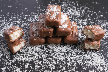 chocolate bars with coconut filling sprinkled with coconut flakes