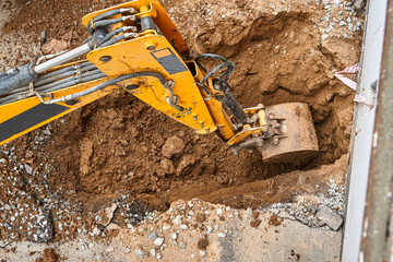 Excavator digs deep pit to change and lay new water pipes