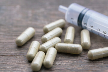 Herbal capsules and syringes.