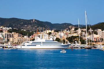 View of the bay of Palma de Mallorca with luxury yachts, buildings, mountains and beautiful clouds. © Сергей Жмурчак