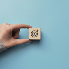 A wooden cube with a target pattern. Symbol of achievement of the set goal
