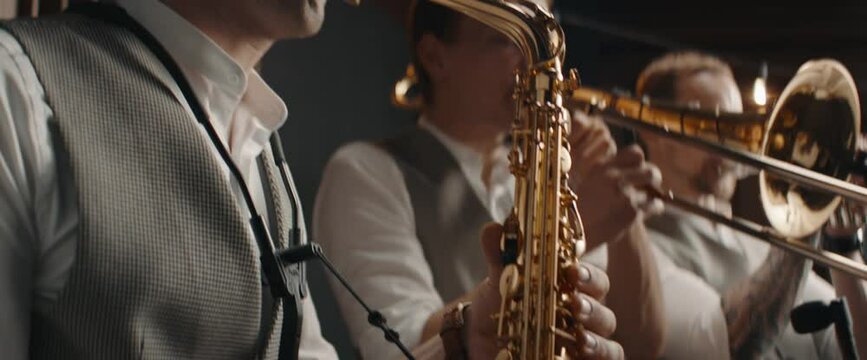 HANHDHELD CU Portrait of jazz band members playing brass instruments in recording studio during rehearsal. Shot on ARRI Alexa Mini with 2x anamorphic lens