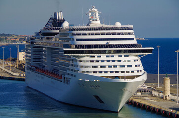 MSC cruiseship Fantasia and other cruise ship liners in port of Civitavecchia, Rome in Italy on sunny summer day seen from departing vessel during Mediterranean cruising