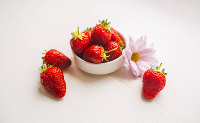 ripe red strawberry on white background as concept of healthy eating and tasty summer dessert