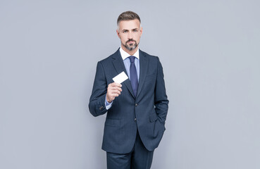 businessman demonstrating credit or debit card. empty plastic business name card.