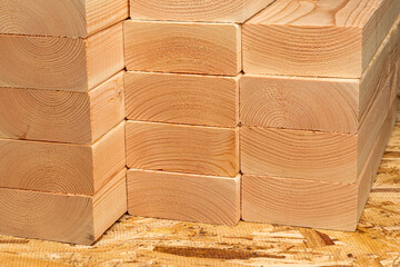 Closeup of construction lumber boards. Building materials price increase, home construction and remodeling cost concept. - obrazy, fototapety, plakaty