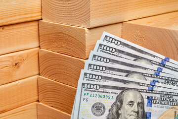Construction lumber with cash money. Building materials price increase, home construction and remodeling cost concept.