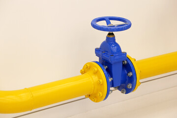 Pipeline with valve. Yellow tube with blue crane, gas industry
