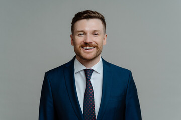 Happy professional businessman in suit smiling at camera