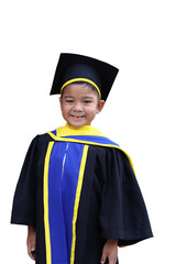 asian boy Wear a symbolic outfit to show success in kindergarten. Or the little graduate dress, dressed in black, yellow and blue, wearing a hat, standing proudly smiling happily. Photo in Thailand.