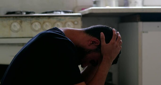 Worried man sitting feeling angst and preoccupation. Person suffering