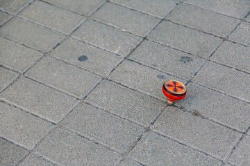 Spinning toy.  Wooden spinning tops  on the floor.
