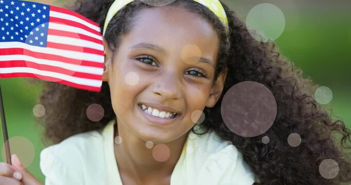 Animation of white circles moving over african american girl holding american flag