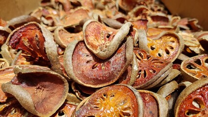 Dried bael fruit background. Close up dried herb. Many of slices of bael fruit .